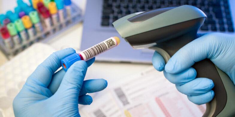 Technician,Hands,Scanning,Bar,Codes,On,Biological,Sample,Tube,In