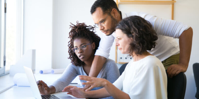 Instructor helping new employees with corporate software