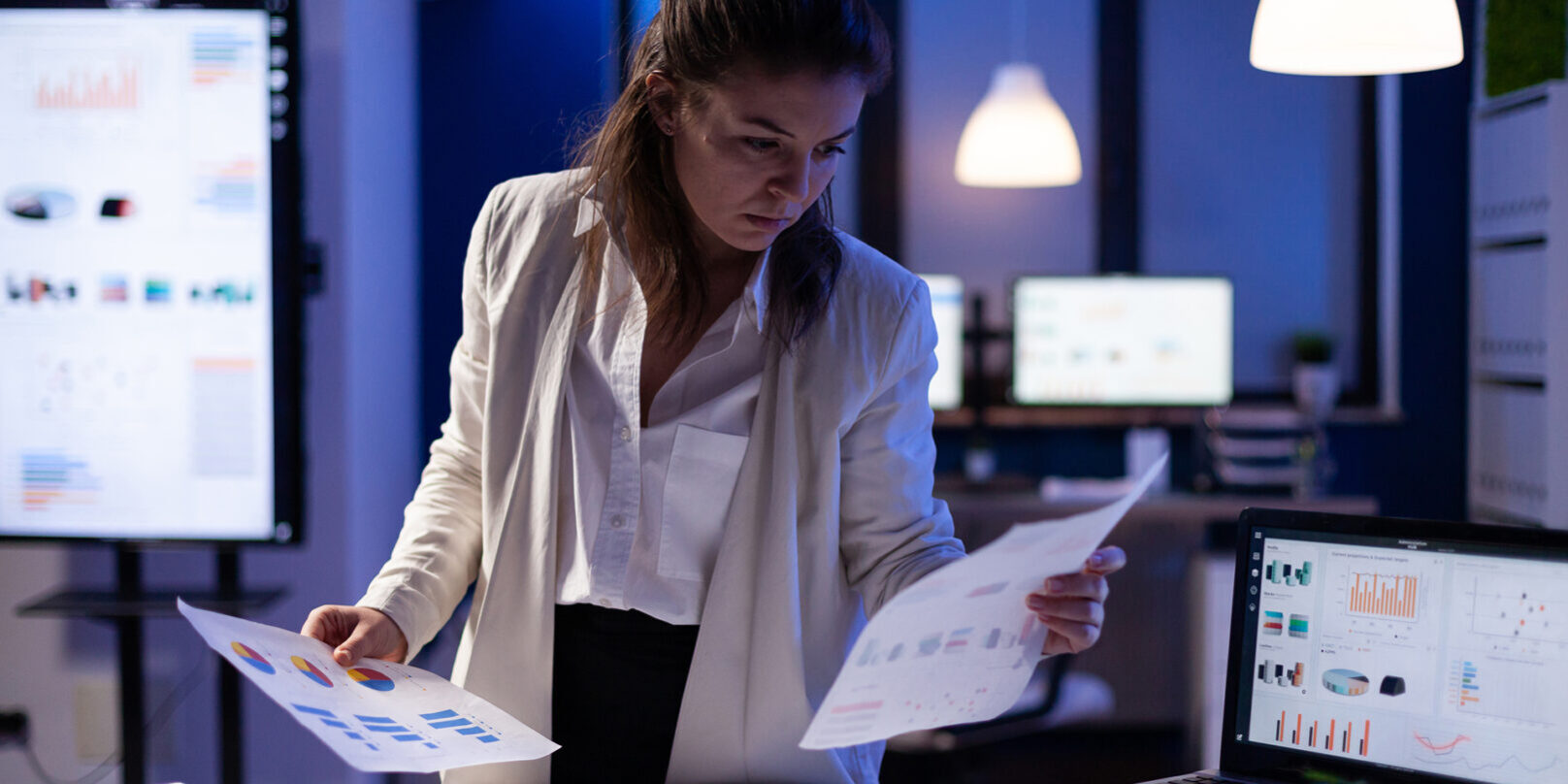 busy-business-woman-looking-financial-reports