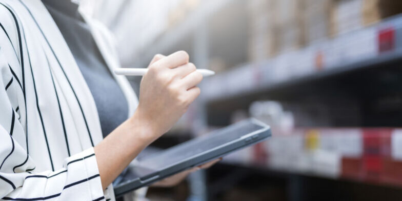 close-up-female-business-owner-hand-hold-tablet-device-checking-inventory-stock-shop-warehouse-distributor-factory-business-ideas-concept